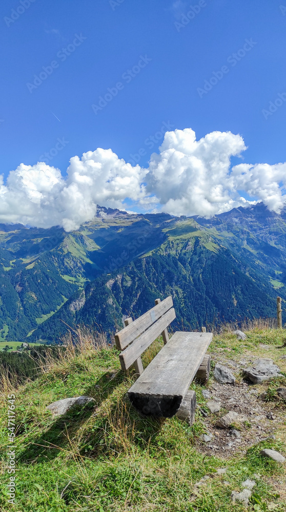 Wooden bench on top of a Mountain without people Wooden bench on top of a Mountain without people