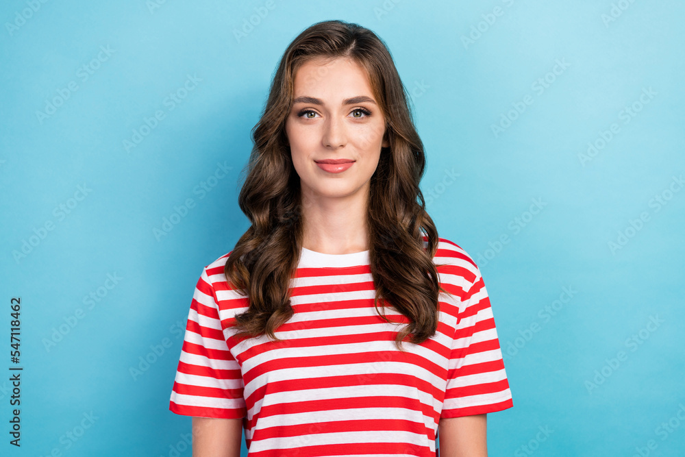 Photo of adorable cheerful young lady wear striped clothes smiling isolated blue color background Photo of adorable cheerful young lady wear striped clothes smiling isolated blue color background