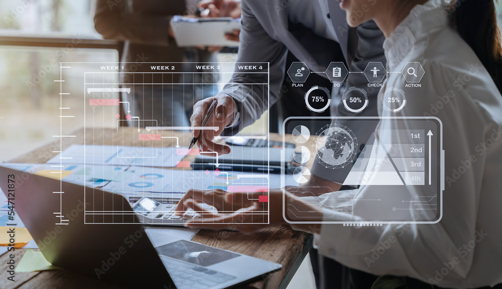 business team and financial concepts about office work. Analysts discuss business with tablet and calculator as a tool.