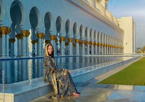 Photography girl walks through a white Arab mosque