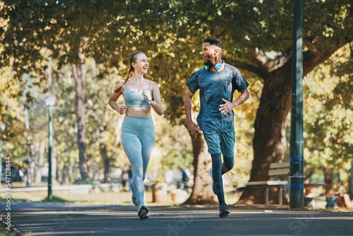 Fototapeta Naklejka Na Ścianę i Meble -  Running, exercise and fitness with a diversity couple in the park for a cardio workout together. Training, motivation and run with a man and woman athlete bonding while exercising outside in the day