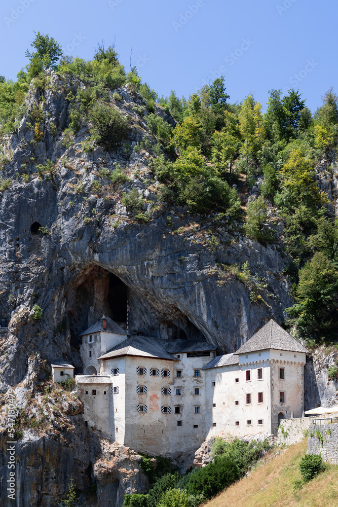 Close to Postojna Cave, Karst world offers an unforgettable experience in fairytale world of knights who built Predjama Castle (Predjamski grad) Postojna, Slovenia (vertical photo)