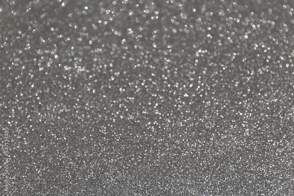 Abstract festive bokeh background. Glitter sparkling silver texture