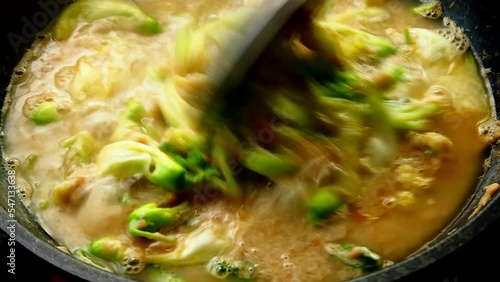 Man is cooking Katuri flowers curry in pot, Thai famous food. photo