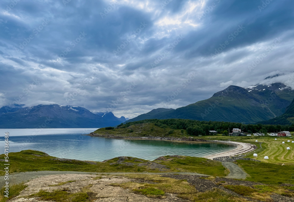 scenery of a beach, mountains and cloudy heaven in Norway. Travel around the world