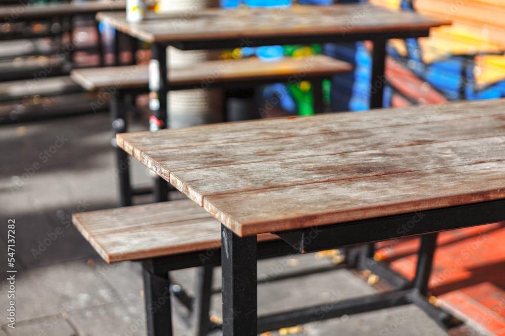 Wooden tables of street terrace . Empty tables of outdoor beer restaurant