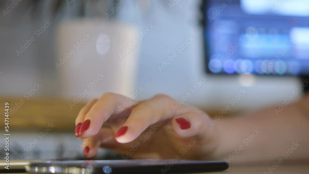 Close-up of a woman hand on a smartphone. Communicate with friends using your smartphone.Finger touch on the cellphone at night.Using mobile phone at home in the evening.Use of mobile phone at night Close-up of a woman hand on a smartphone. Communicate with friends using your smartphone.Finger touch on the cellphone at night.Using mobile phone at home in the evening.Use of mobile phone at night