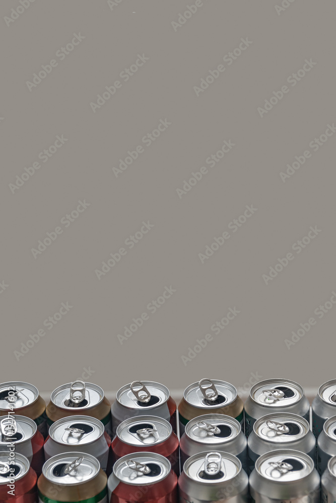 Cover page with a group of empty aluminum beer cans standing in order for recycling. Concept of recycling metal and plastic with copy space and grey solid background Cover page with a group of empty aluminum beer cans standing in order for recycling. Concept of recycling metal and plastic with copy space and grey solid background