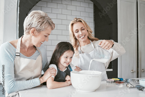 .Cooking, learning and family in kitchen with milk jug for food mixing preparation with smile. Happy, wellness and excited child watching mother pouring baker ingredients with grandma in home.