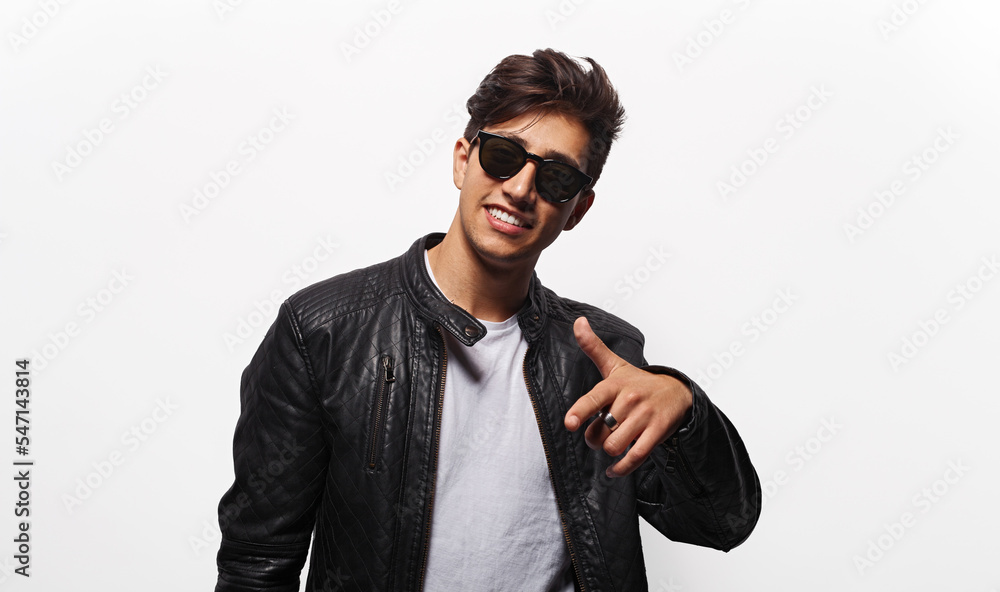 Cool young man pointing forward Cool young man pointing forward
