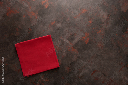 Top of view red napkin on dark concrete table, vintage.
