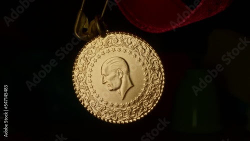A spinning Republic of Turkey gold coin. Atatürk silhouette. Mustafa Kemal Atatürk in relief. 4K photo