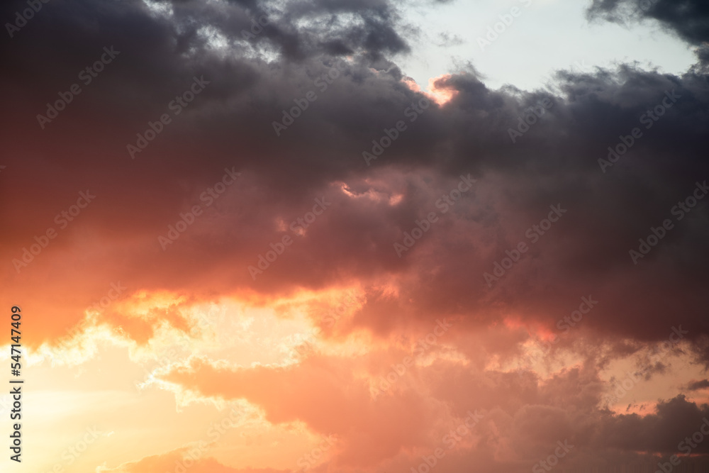 Obraz premium Dramatic clouds formations during a colorful sunset after a summer storm