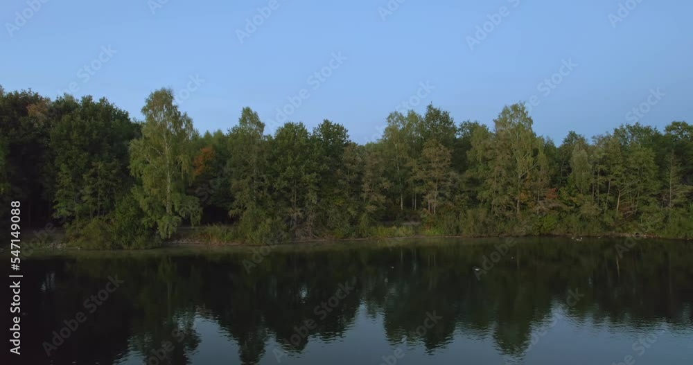 zoom out view of lake with drone, drone landscape footage at sunset. 4K, Gronau in Germany zoom out view of lake with drone, drone landscape footage at sunset. 4K, Gronau in Germany