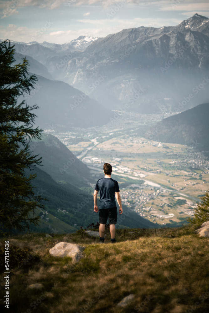 A person is looking over the Chiavenna Valley from the top of Mount Berlinghera, in the Northern Italy