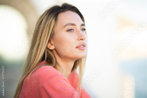 Close up portrait beautiful young caucasian woman with blond hair looking away