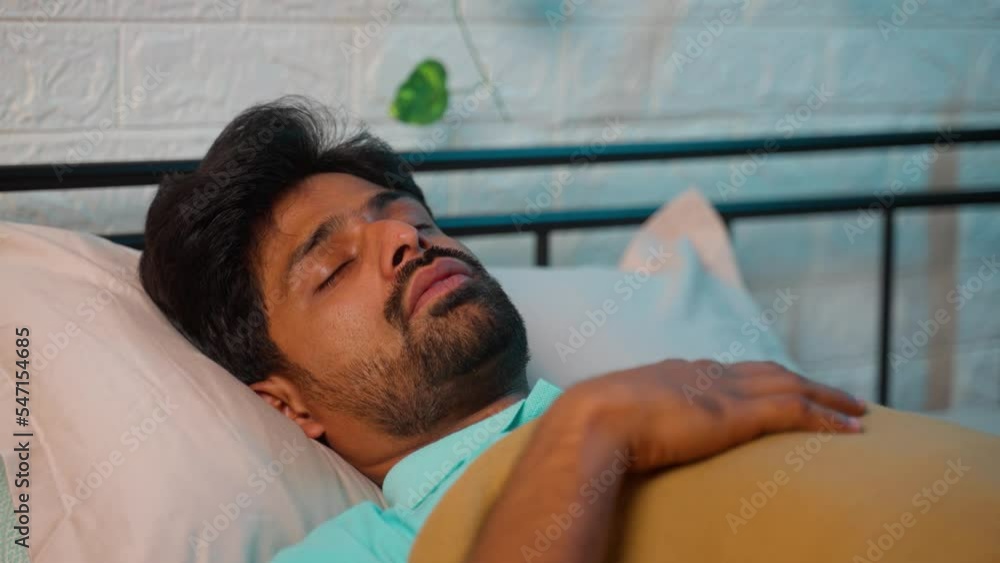 close up shot of man sleeping by snoring with mouth open during night - concept of relaxation, apnea and napping
