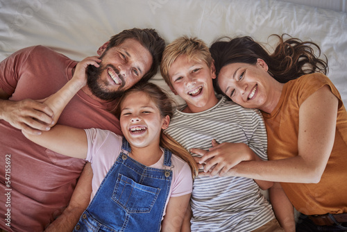 Family, bed and happy portrait above in morning bonding, love or care for children in family home. Mom, dad and kids in bedroom with happiness, holiday or vacation to rest, relax or smile together