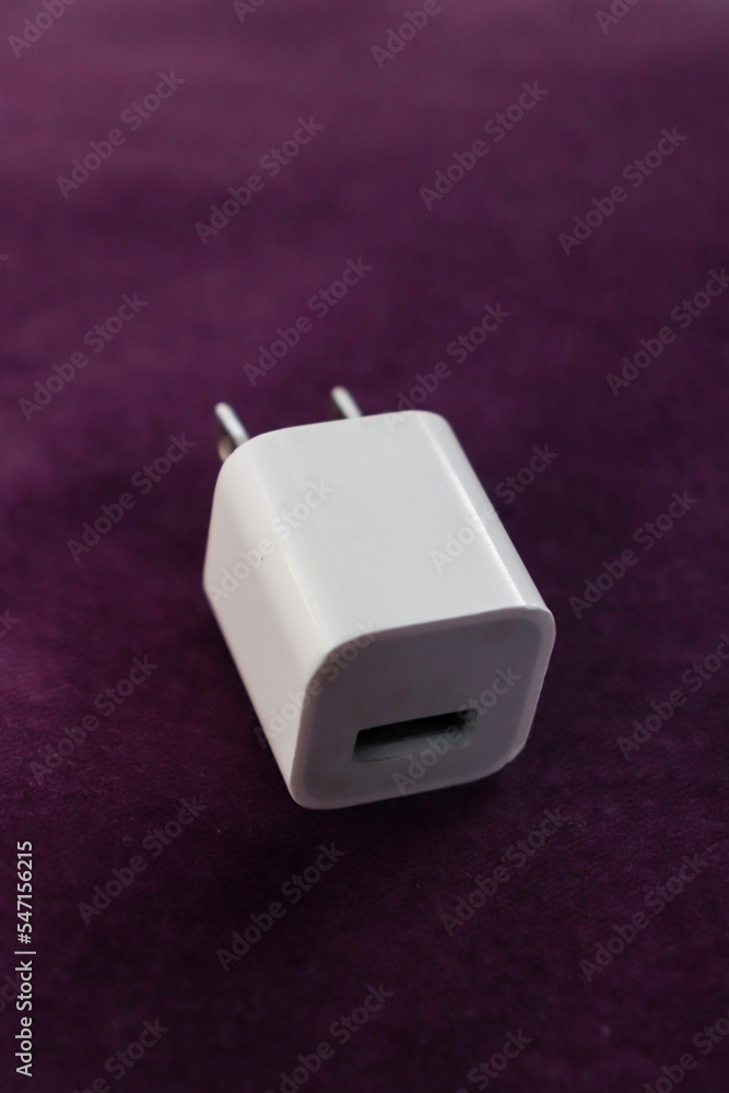 White USA USB Power Adapter block isolated on dark purple background White USA USB Power Adapter block isolated on dark purple background