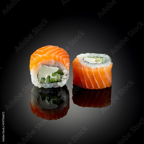 Japanese sushi with seafood with reflection on black background. Poster sushi bar menu photo concept 