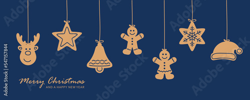 Leinwand Poster christmas card with hanging gingerbread cookies decoration on blue background