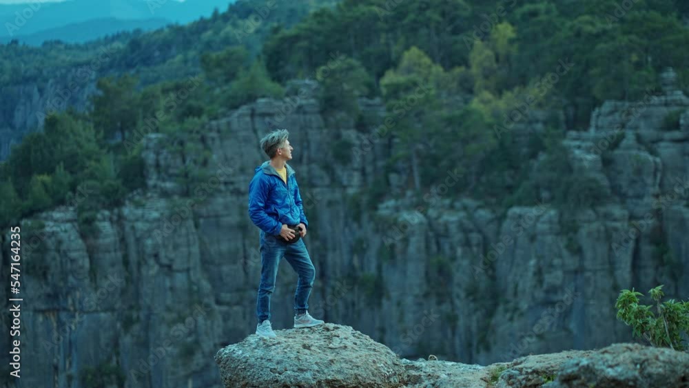 hiker tourist man standing on cliff of Tazi Canyon in Turkey, enjoying beautiful panoramic nature view