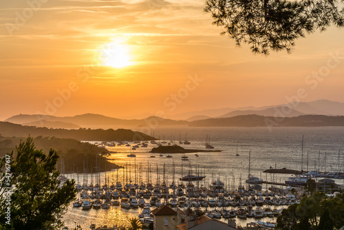 Scenic view of golden summer sunset over the island of Porquerolles in south of France with reflection to the Mediterranean sea