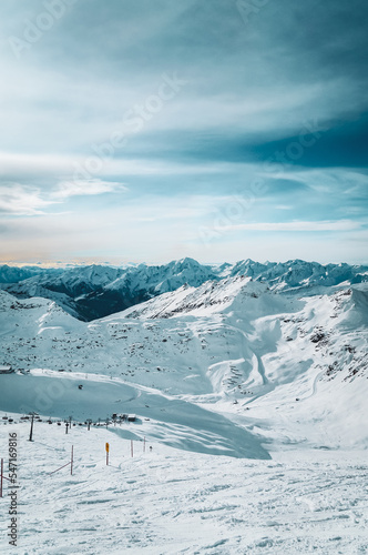 Snowy mountain landscape with ski lift and frozen reservoir in breathtaking winter atmosphere photographed at Mölltal Glacier ski resort. Mölltaler glacier, Flattach, Kärnten, Austria, Europe.