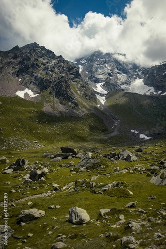 Verticlal shot of rocky hills at the green valley photo