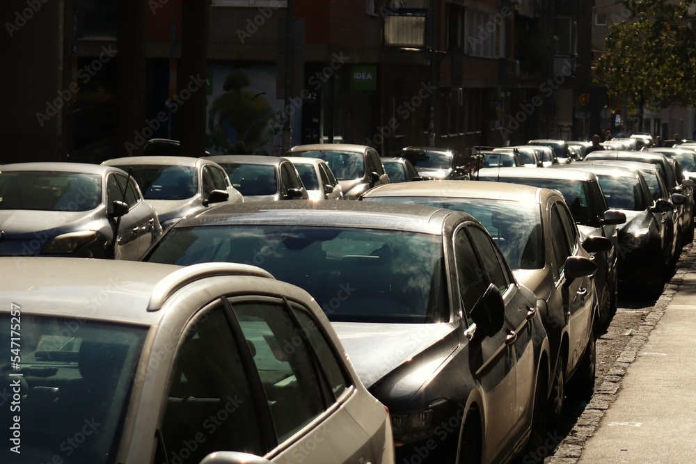 Sunny day, street full of parked cars Sunny day, street full of parked cars