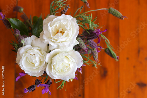 Natural flowers bouquet  white roses in a blur wooden background