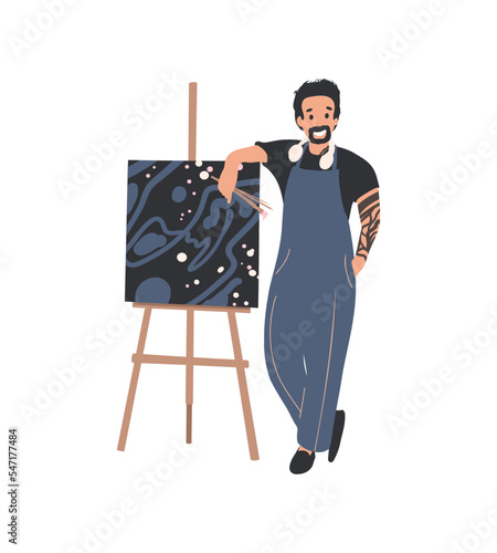 Man Artist painting picture on easel. Hobby, art studio, art classes concept. Painter with paint palette and brush working.