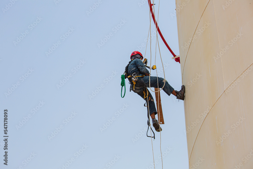 Top view pic of industrial rope access welder working at height wearing