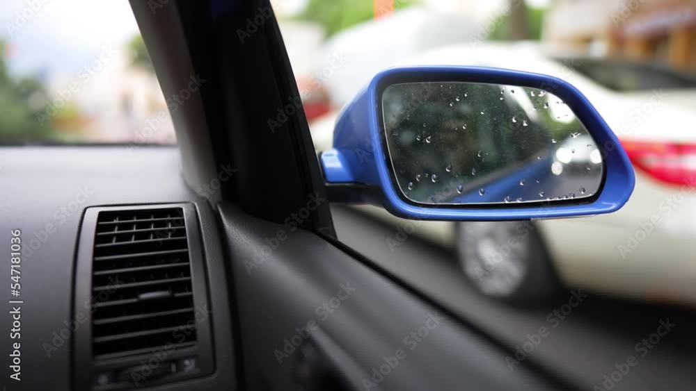 Slow motion video of a modern blue car right side mirror, while driving on a street. Slow motion video of a modern blue car right side mirror, while driving on a street.