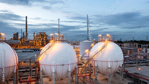 Photos Gas storage sphere tank in petrochemical industry zone with oil and gas refinery factory plant petrochemical industry and oil storage tank background, Oil refinery at twilight
