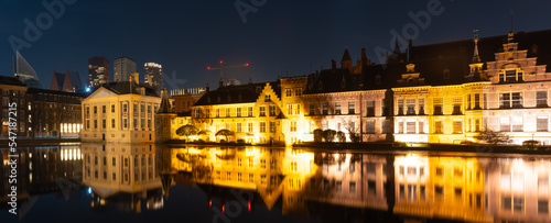 Panorama of The Hague at night, view of historical complex Binnenhof with famous Mauritshuis museum, Hofvijver lake and small octagonal building known as The Torentje