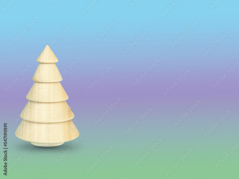 A wooden Christmas tree on a multicolored gradient background A wooden Christmas tree on a multicolored gradient background