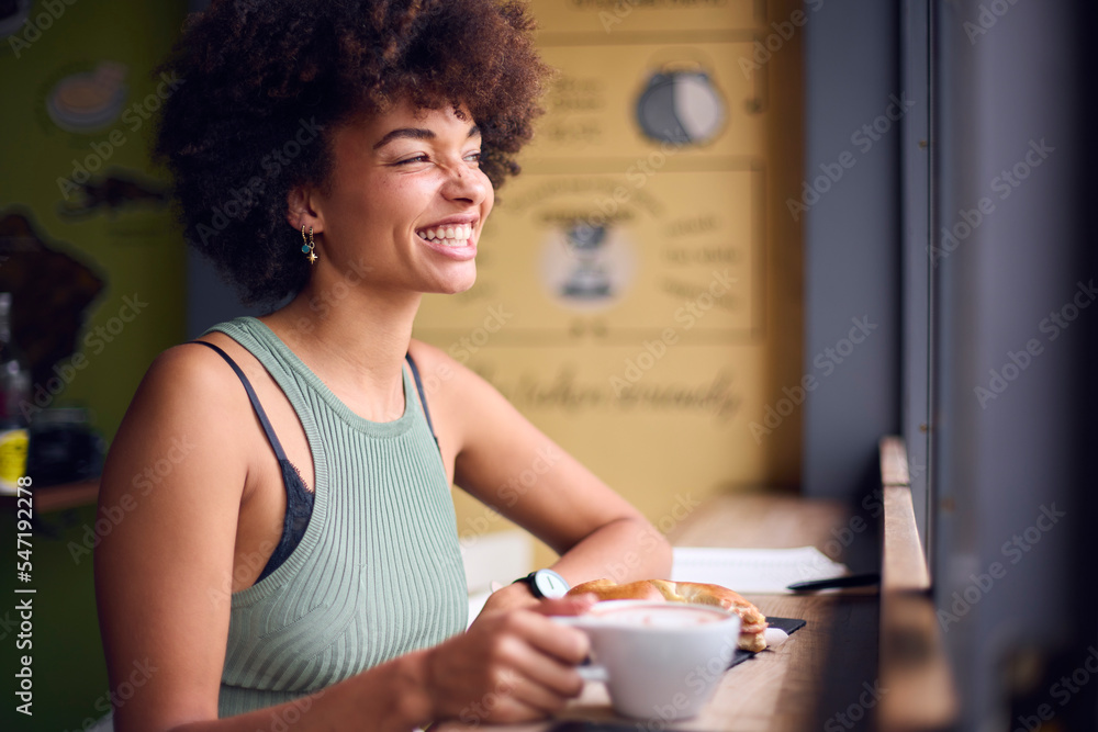 Female Customer In Coffee Shop Window Working Writing In Notebook Female Customer In Coffee Shop Window Working Writing In Notebook