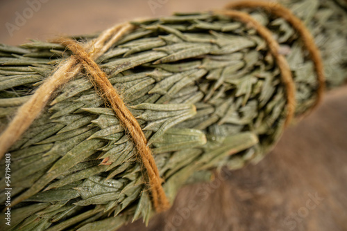 siskiyou cedar incense bundle on a textured bark paper, aromatherapy concept, macro shot photo