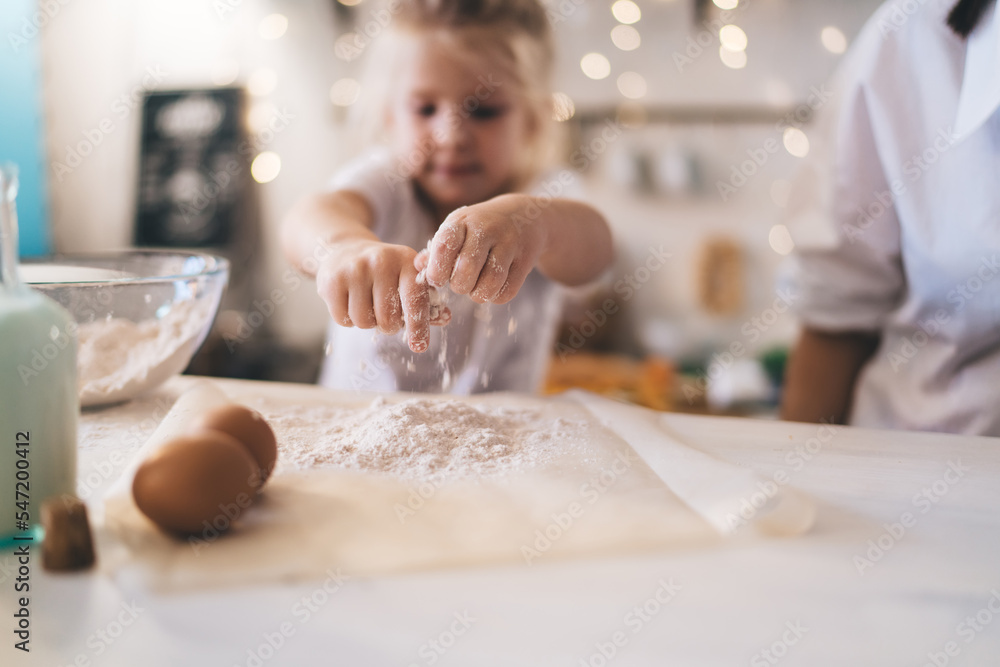 Cute little girl pouring flour in kitchen Stock Photo | Adobe Stock