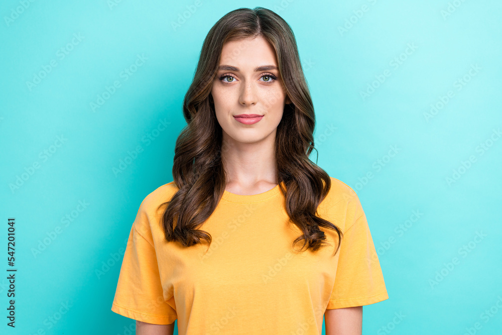 Fototapeta premium Photo of nice positive gorgeous girl with wavy hairdo dressed yellow t-shirt look at camera isolated on turquoise color background