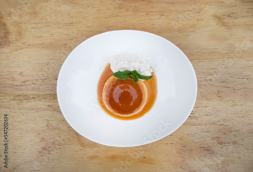 Traditional gourmet dessert. Top view of a flan with cream and caramel.
