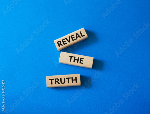 Reveal the truth symbol. Concept word Reveal the truth on wooden blocks. Beautiful blue background. Business and Reveal the truth concept. Copy space