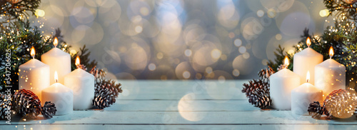Advent white candles with decor in shiny lights