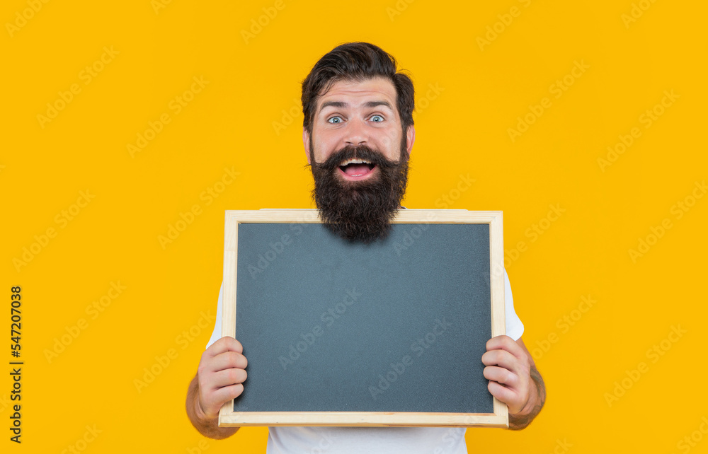 amazed bearded man advertising on blackboard with copy space. bearded man advertising amazed bearded man advertising on blackboard with copy space. bearded man advertising