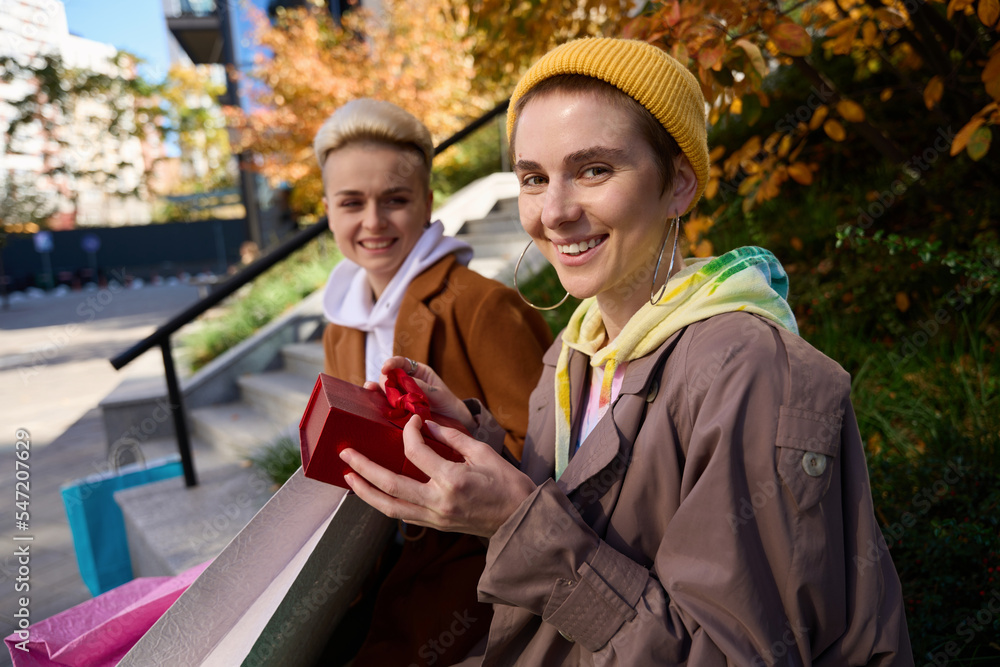 Joyful woman holds red box with gift in her hands