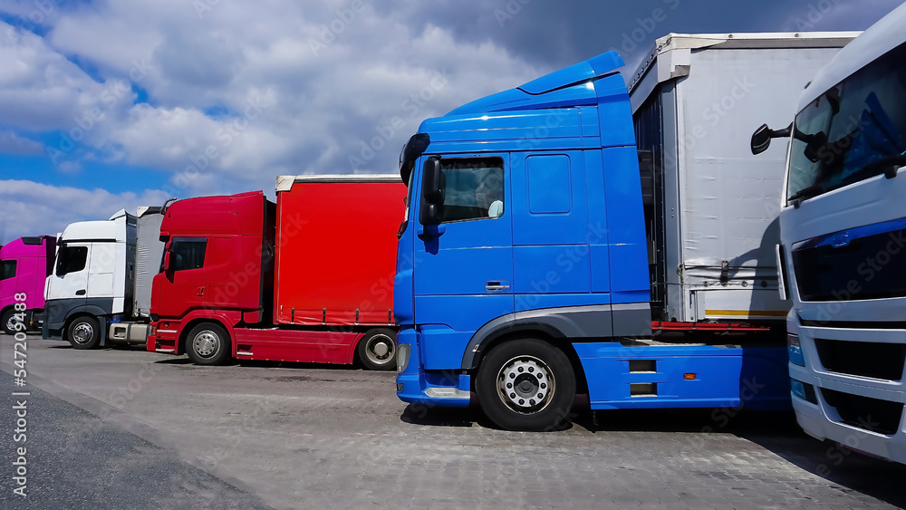 Fototapeta premium Trucks at parking lot. Delivery Trucks. Cargo Shipping. Lorry. Industry Freight Truck Logistics Cargo Transport Concept.