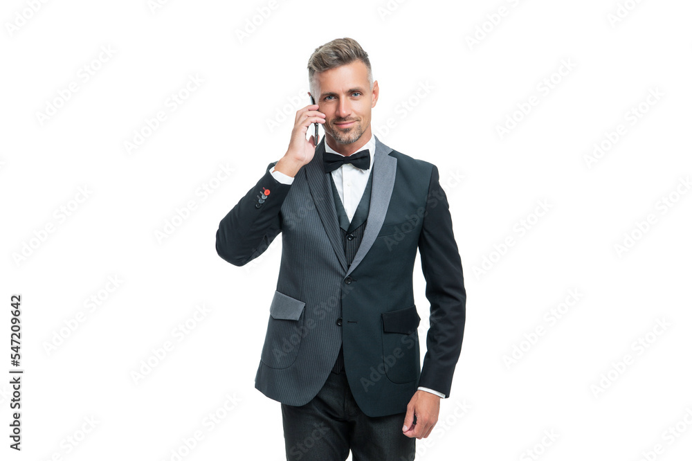 entrepreneur in tux speaking on smartphone isolated on white background entrepreneur in tux speaking on smartphone isolated on white background