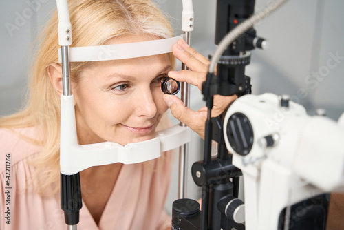 Adult woman sitting at an eye tester