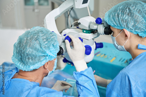 Close up photo of doctors doing eye microsurgery
